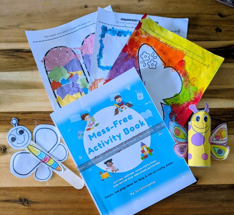 A flat lay image of the mess-free activity book, finished pages from the book and supplies needed to enjoy the book
