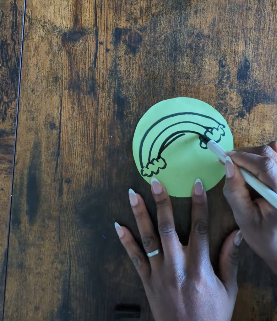 Clear plastic Pringles snack lid used as a reusable DIY dry-erase tracing board with a white paper circle insert for letter practice.