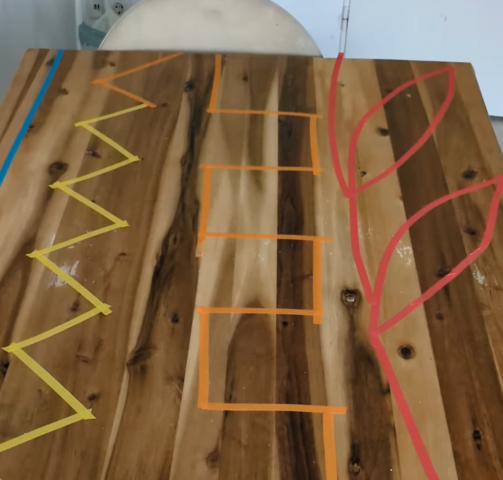 Small wooden toy figures being moved along a zigzag painter's tape track on the floor for a toddler coordination and concentration activity.