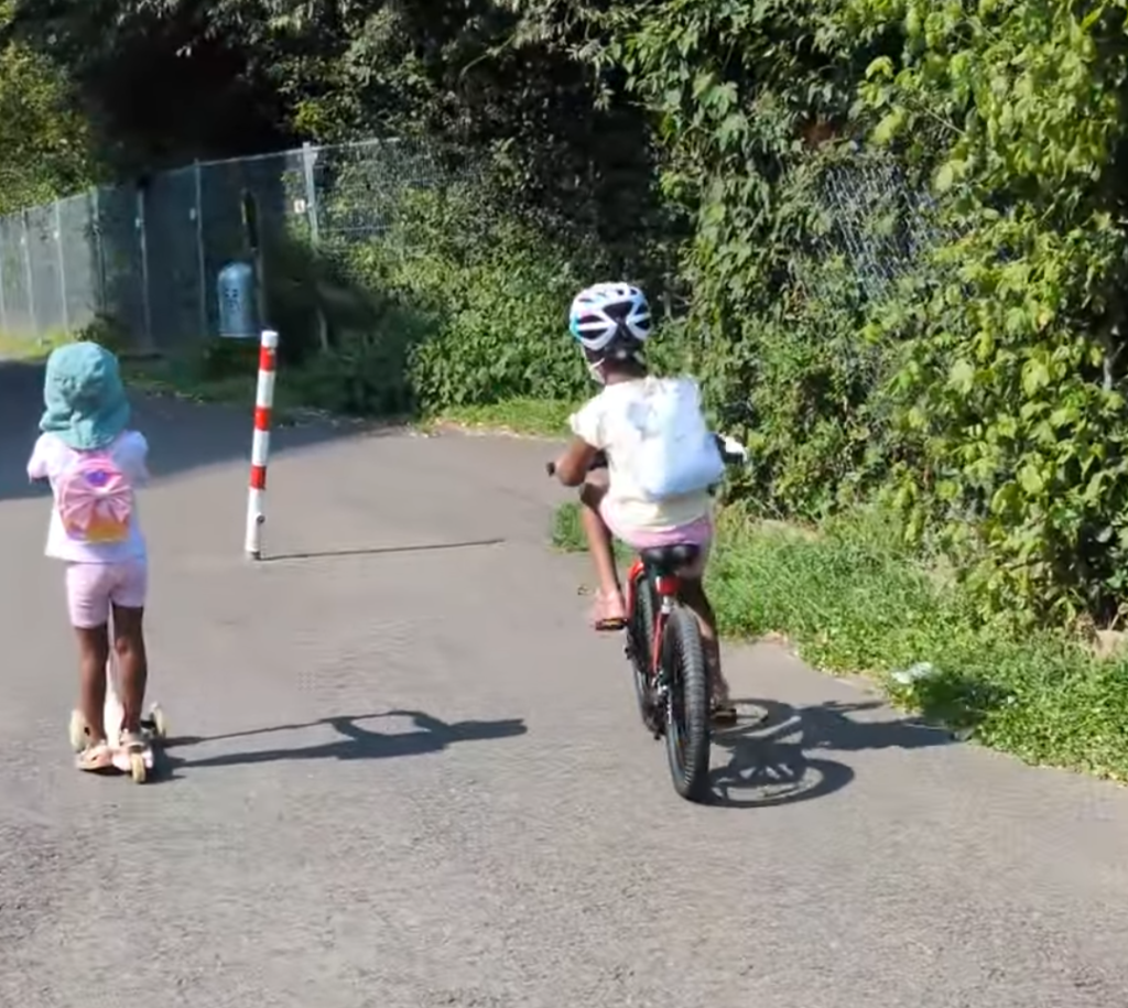 Children riding bicycles outdoors to burn energy during the long afternoon stretch.